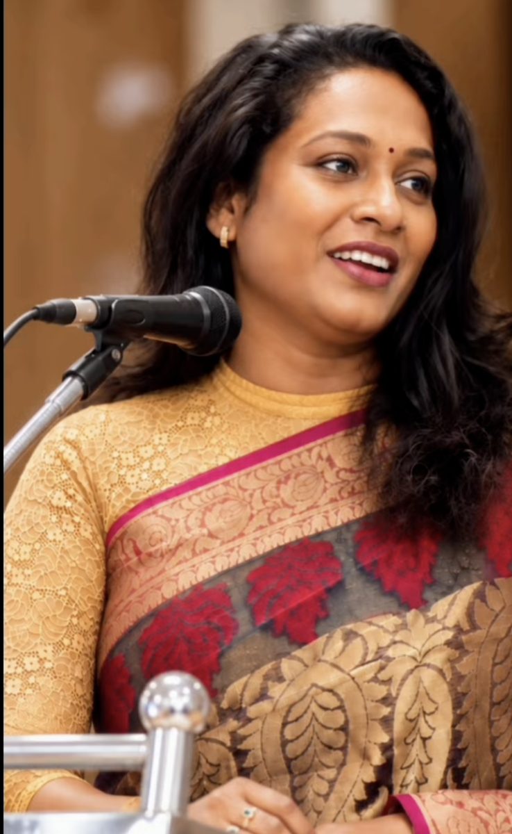 Devi speaking at an event